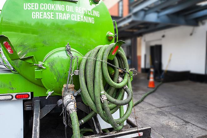 a grease trap pumping truck at a restaurant in Cochranton